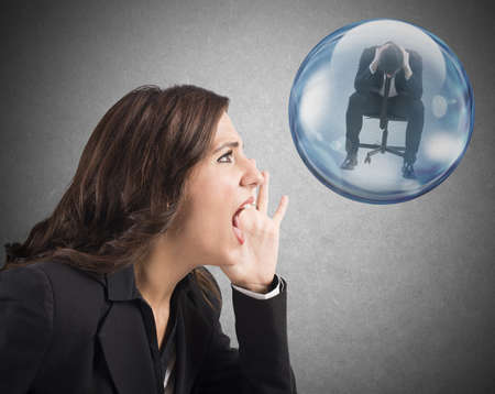 Woman yelling to man inside a bubbleの写真素材