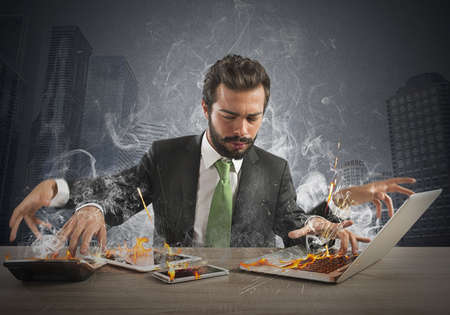 Stressed businessman working quickly with many computer