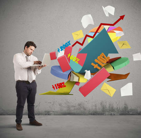 Businessman working at computer graphs and percentagesの写真素材