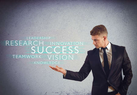 Successful businessman with words over his handの写真素材