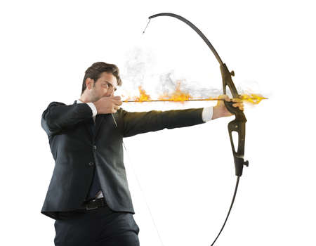Determinated businessman with flaming arrow takes aimの写真素材
