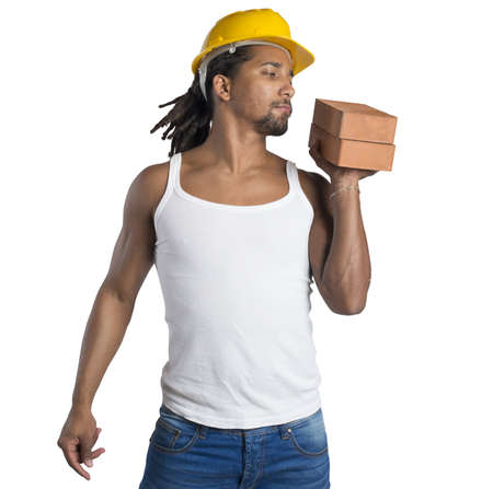 Sexy man mason builds buildings with bricksの写真素材