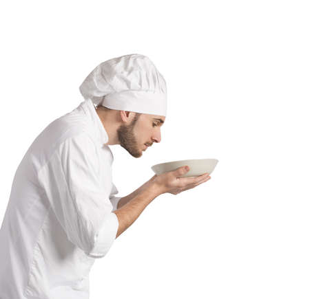 Man chef smelling the aroma of his dishの写真素材