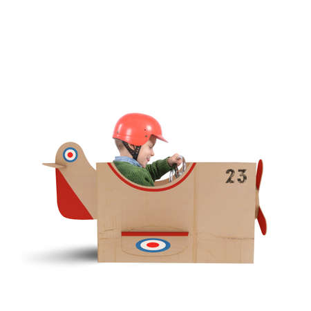 Child flies with his plane of cardboardの写真素材