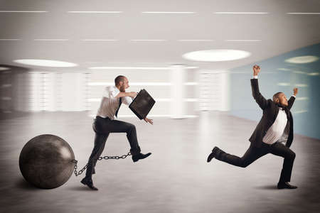 Man competing with a man with obstacleの写真素材