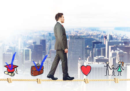 Successful businessman walking on a life ropeの写真素材
