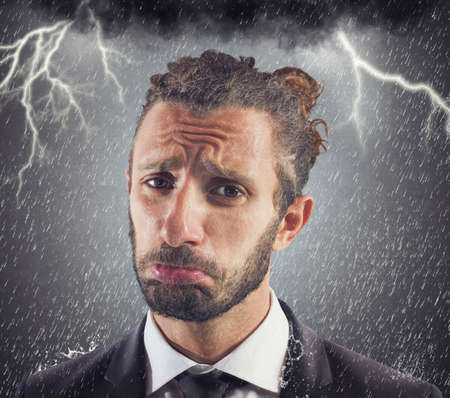 Portrait of sad businessman with storm backgroundの写真素材