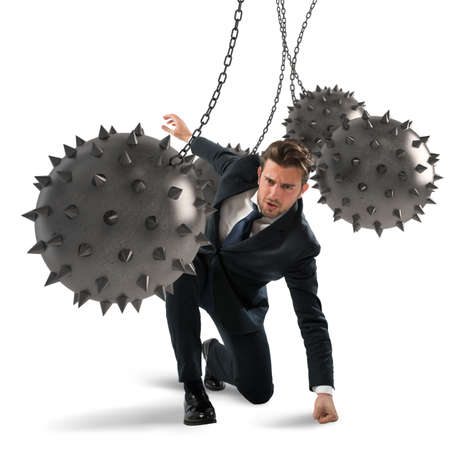 Businessman between fierce spiky balls that hinderの写真素材