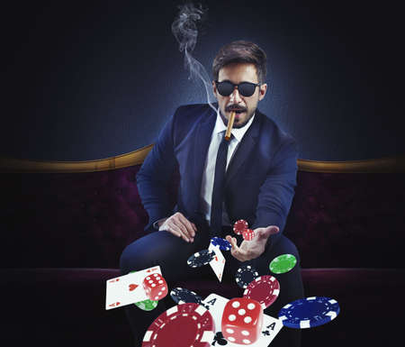 Rich gambler throws cards dice and chipsの写真素材