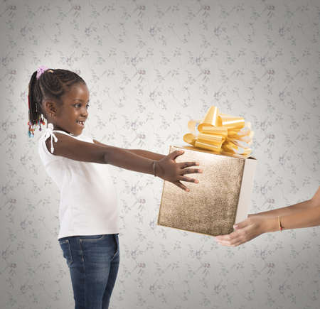 Excited little girl receives an unexpected presentの写真素材
