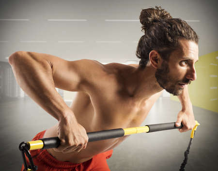 Muscular man training with a weight barの写真素材