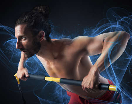 Muscular man training with a weight barの写真素材
