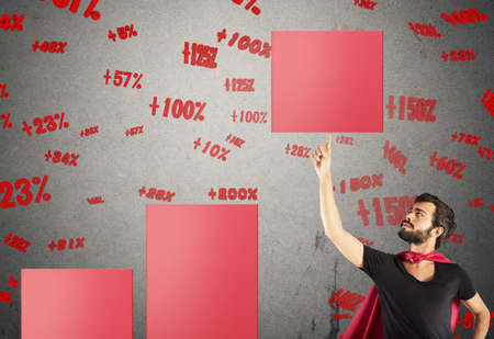 Hero businessman raises a step of statisticの写真素材