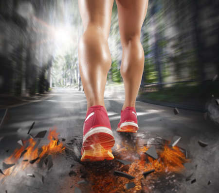 Woman runs leaving a trail of fireの写真素材