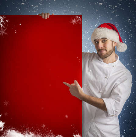 Chef shows a red billboard of christmasの写真素材