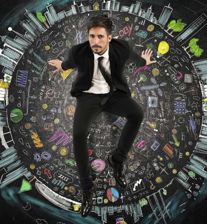 Businessman sitting on a circle of symbolsの写真素材