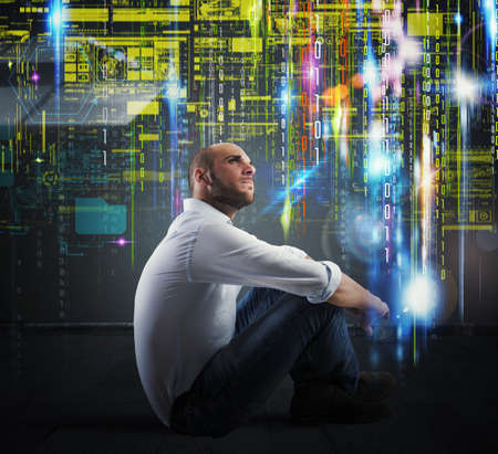 Man sitting with background of binary codesの写真素材