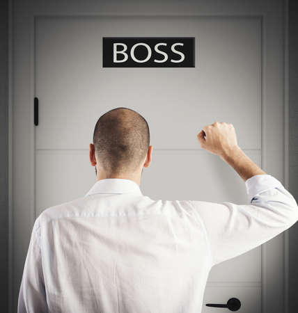Employee knocks on the door of bossの写真素材
