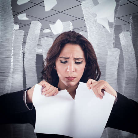 Woman nervous and stressed tears a worksheetの写真素材
