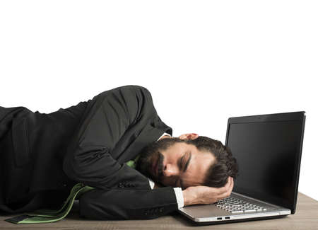 Businessman workload falls asleep tired on computerの写真素材