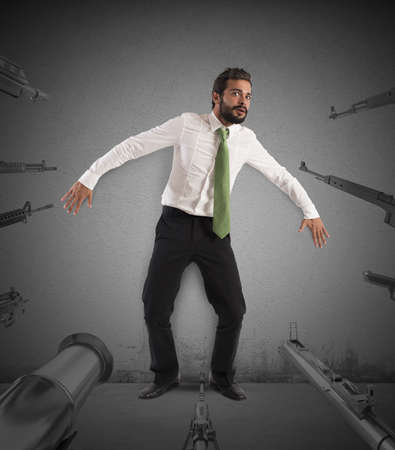 Guns trained on a man very scaredの写真素材