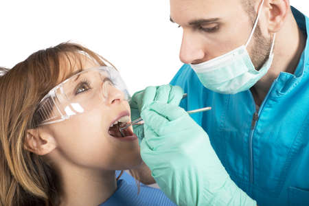 Dentist effects a cleaning of the teethの写真素材