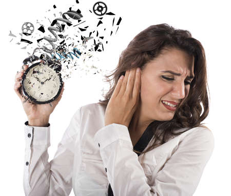 Woman annoyed by the sound of alarmの写真素材