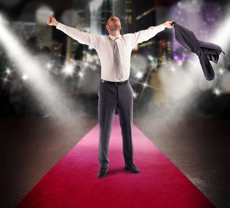 Winner businessman rejoices on a red carpetの写真素材