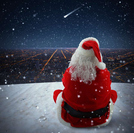 Santa Claus watches a sparkling falling starの写真素材