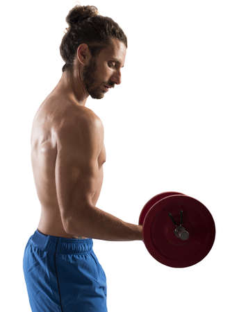 Sexy shirtless man training biceps with weightsの写真素材
