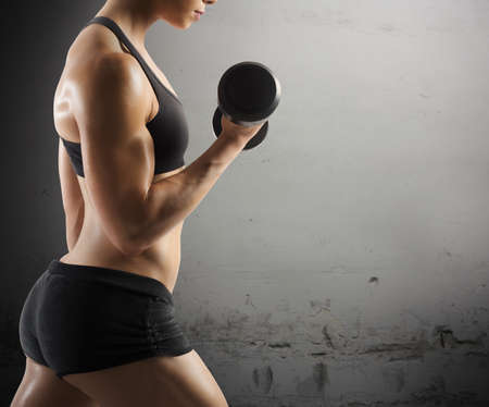 Athletic muscular woman workout with grunge backgroundの写真素材