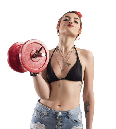 Pin-up girl with tattoo lifting a weightの写真素材