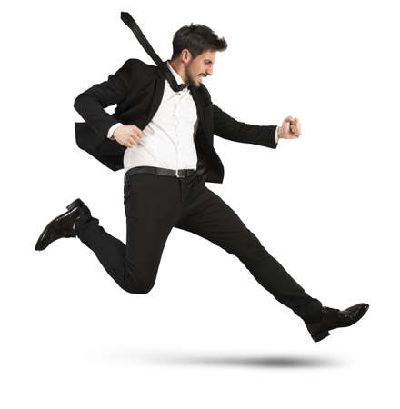 Determined businessman with the suit quickly runsの写真素材