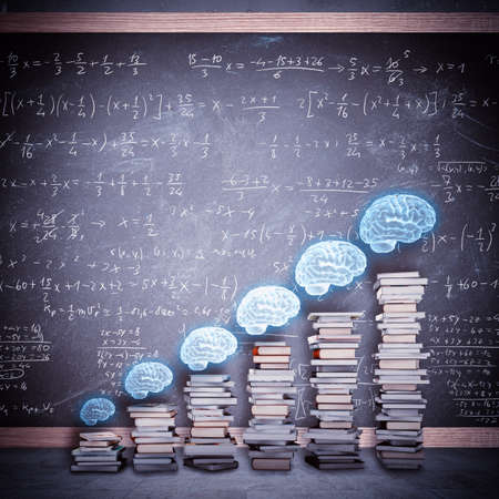Scale of school books with brains above