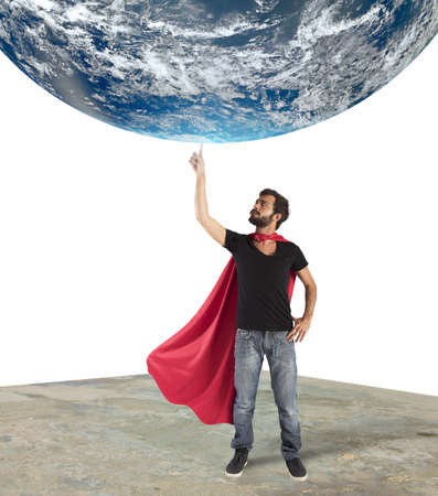 Superhero holds the world with a finger.  の写真素材
