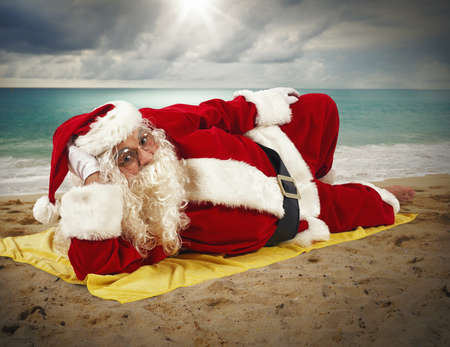 Santaclaus relaxing at the beach on towelの写真素材