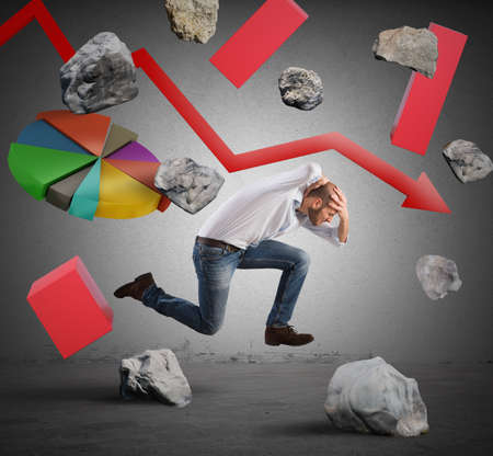 Running businessman escapes from difficulties and economic crisisの写真素材