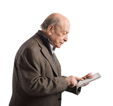 Old man surfing the internet with tabletの写真素材