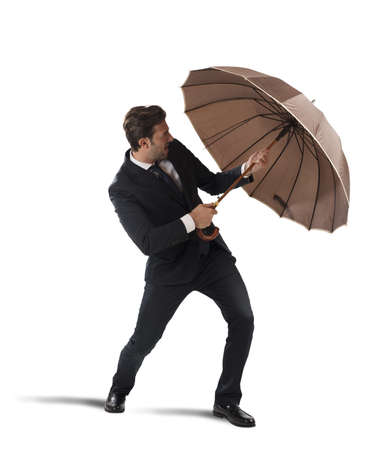 Businessman protect himself with umbrella on white backgroundの写真素材