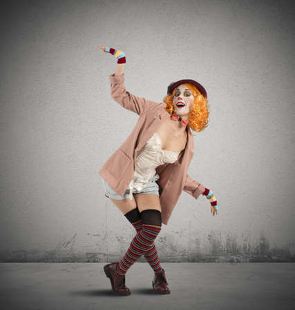 Colorful clown woman in a extravagant poseの写真素材