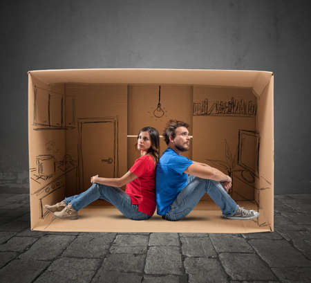 Couple in a house designed in cardboardの写真素材