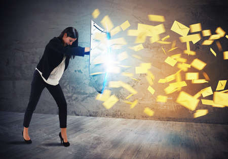 Businesswoman is protected with shield by lettersの写真素材