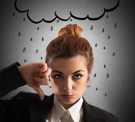 Woman with sad expression with drawn cloudの写真素材