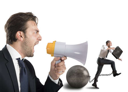 Boss reproach employee who runs with impedimentの写真素材