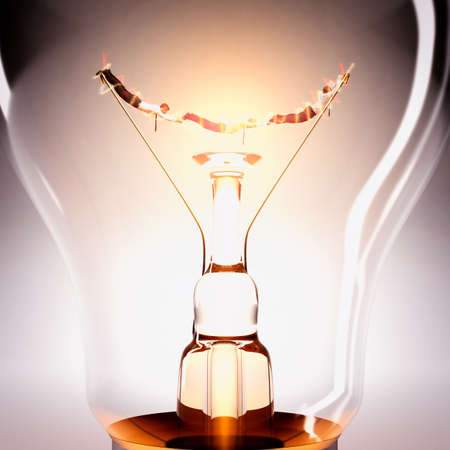 Businessperson help each other in a lightbulbの写真素材