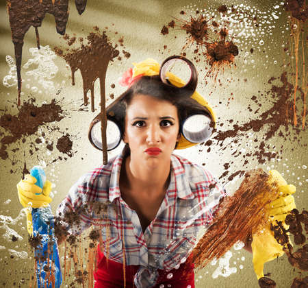 Housewife with disgusted expression cleaning dirty glassの写真素材