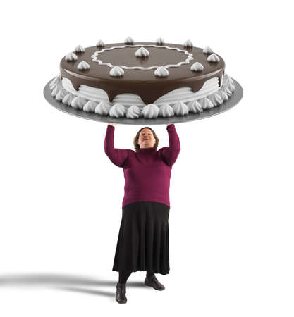 Fat woman holding a big chocolate cakeの写真素材