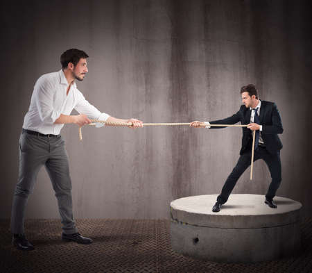 Big businessman pulls rope against small businessman