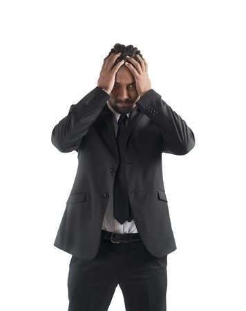 Desperate exhausted businessman with head in handsの写真素材