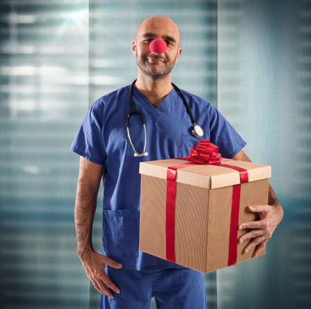 Nurse with clown nose and big giftの写真素材